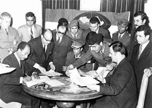 Assad signing the Federation of Arab Republics in Benghazi, Libya, on 18 April 1971 with President Anwar al-Sadat (sitting left) of Egypt and Colonel Muammar al-Qaddafi of Libya (sitting in the centre).